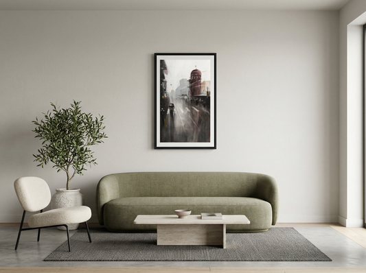 Modern living room with a green sofa, white chair, and framed artwork on the wall.
