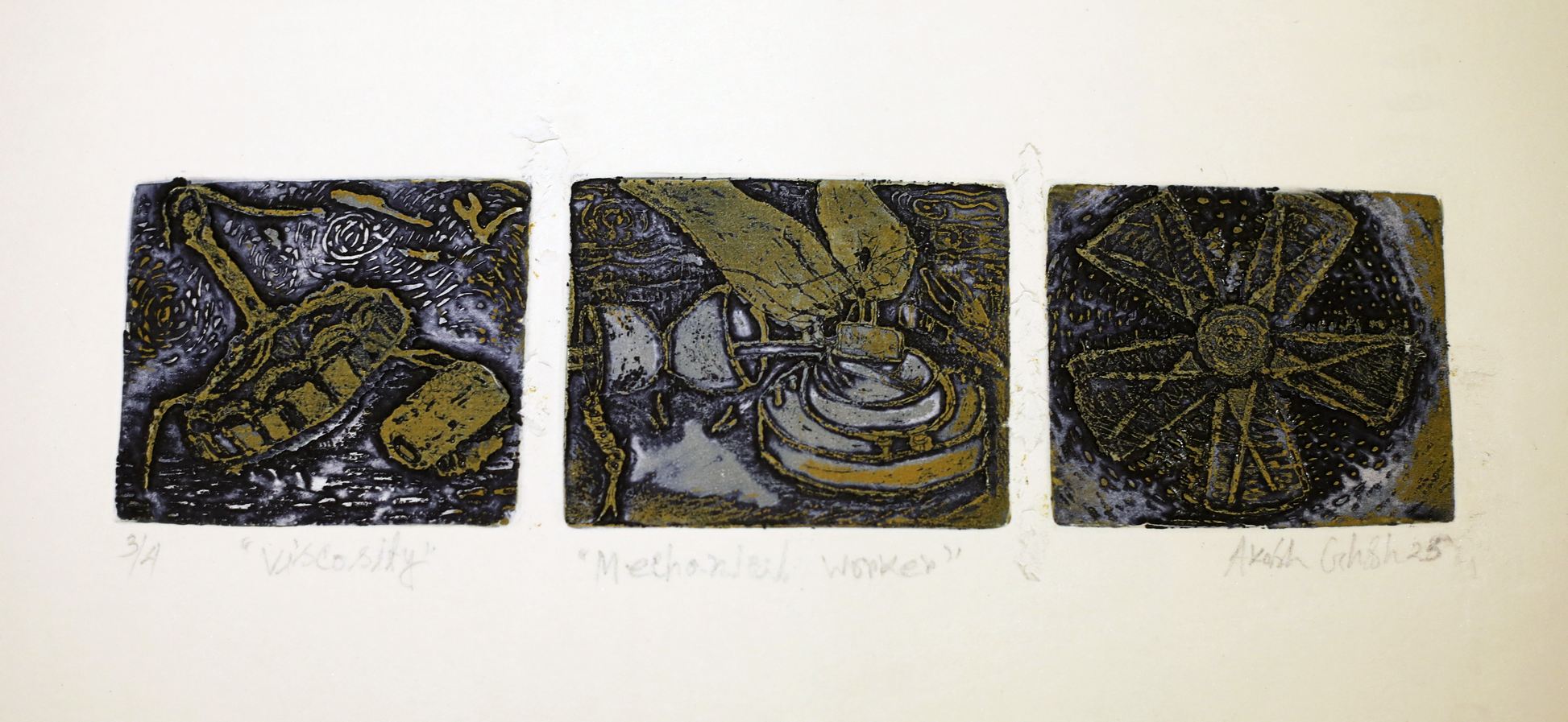 Three square tiles with artistic designs in black and gold on a beige background